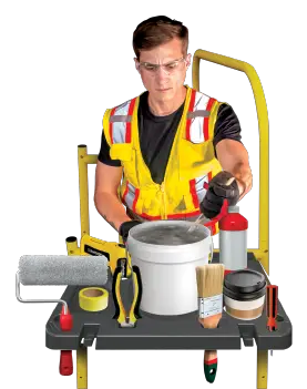 A closeup of the tool shelf holding painting supplies, tools, and a coffee cup.